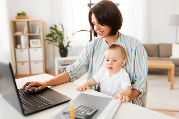 Image showing working mother with baby boy and laptop at home