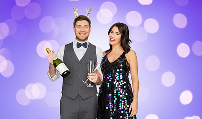 Image showing couple with champagne bottle at christmas party