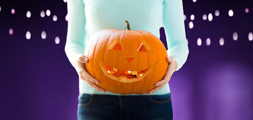 Image showing close up of woman holding halloween pumpkin