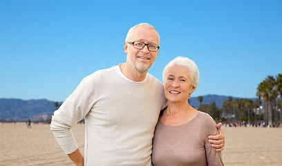 Image showing happy senior couple hugging over venice beach