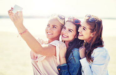 Image showing group of smiling women taking selfie on beach