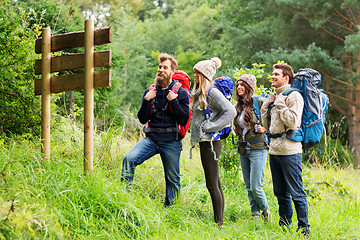 Image showing hiking friends with backpacks at signpost