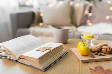 Image showing book, lemon, tea and cookies on table at home