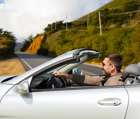 Image showing man driving convertible car over big sur hills