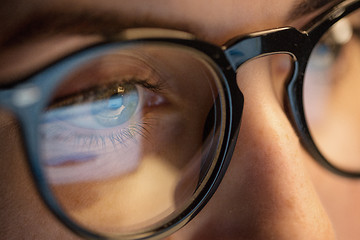 Image showing close up of woman in glasses looking at screen