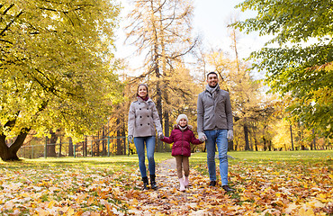 Image showing happy family walking at autumn park