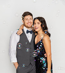 Image showing happy couple hugging in soap bubbles at party