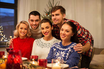 Image showing happy friends celebrating christmas at home