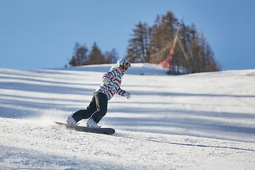 Image showing Female snowboarder on the slope