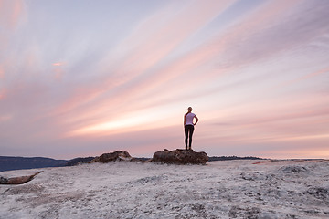 Image showing Girl stands awestruck dmiring the Blue Mountains Sunset