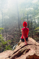 Image showing Female taking shelter from the rain in a cave overhang Blue Mountains