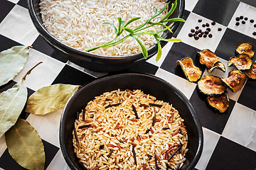 Image showing Rice and spices on checked kitchen counter