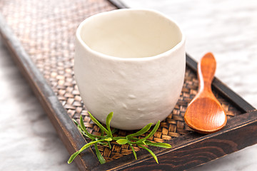 Image showing Ceramic teacup on a wooden tray