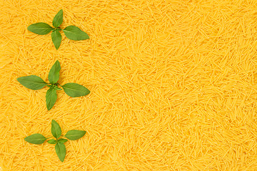 Image showing Fresh basil leaves decorating noodles background