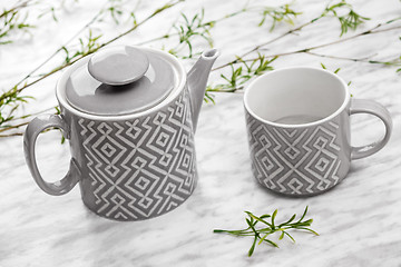 Image showing Ceramic teapot and cup on marble surface