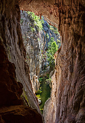 Image showing Views through the tinted cave to the narrow canyon