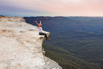 Image showing Live your life to the full. Girl on cliff ledge