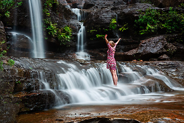 Image showing Adventurous female standing in waterfalls