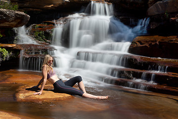 Image showing Relaxing in the sunshine by a tranquil waterfall