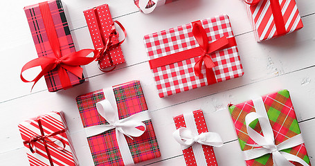 Image showing Top view of wrapped Christmas presents laid on the wooden table