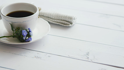 Image showing Black coffee in white cup on bright wooden background.