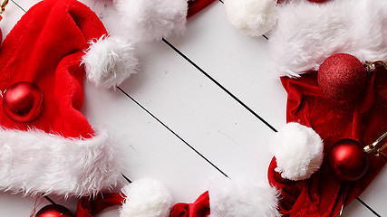 Image showing Santa Claus hats on white wooden desk with blank copy space.