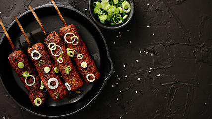 Image showing Barbecued turkey kebab decorated with fresh onion