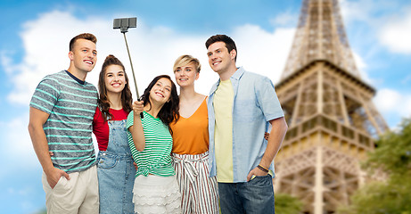 Image showing friends taking selfie by monopod over eiffel tower