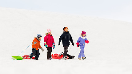 Image showing happy little kids with sleds in winter