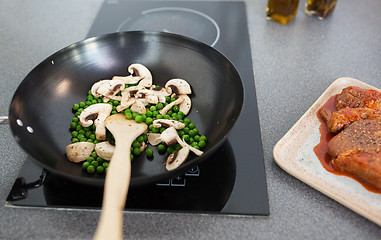 Image showing close up of food in frypan on cooking panel