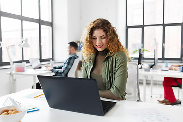 Image showing creative woman with laptop working at office