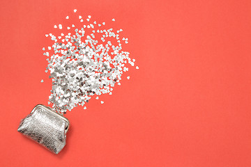 Image showing Shiny hearts and silver purse on pink background