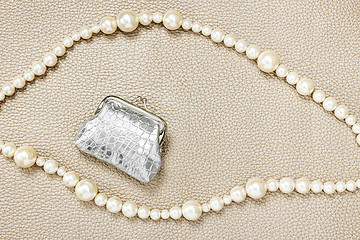 Image showing Silver purse and pearl necklaces