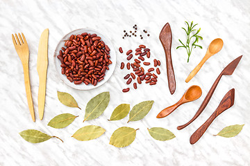 Image showing Beans, spices and wooden utensils on marble background