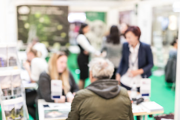 Image showing Anonymous blurred people discussing business at a trade fair.