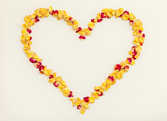 Image showing Heart made of yellow and red rose petals