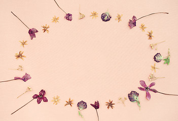 Image showing Wild flowers frame on pink canvas background