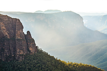 Image showing Sunlight hits fine rising mist out of the valley