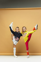 Image showing Two happy children show different sport. Studio fashion concept. Emotions concept.