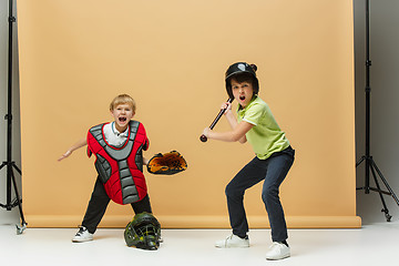 Image showing Two happy children show different sport. Studio fashion concept. Emotions concept.