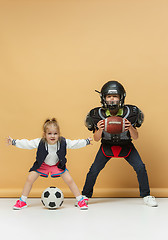 Image showing Two happy and beautyful children show different sport. Studio fashion concept. Emotions concept.