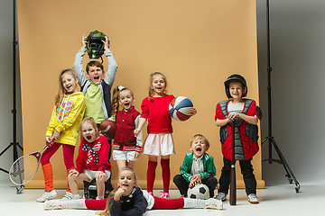 Image showing Group of happy children show different sport. Studio fashion concept. Emotions concept.