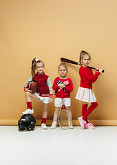 Image showing Happy and beautyful children show different sport. Studio fashion concept. Emotions concept.