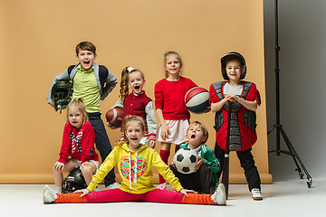 Image showing Group of happy children show different sport. Studio fashion concept. Emotions concept.