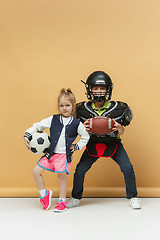 Image showing Two happy and beautyful children show different sport. Studio fashion concept. Emotions concept.