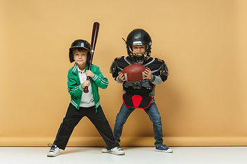 Image showing Two happy children show different sport. Studio fashion concept. Emotions concept.