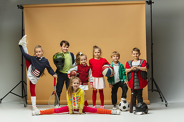 Image showing Group of happy children show different sport. Studio fashion concept. Emotions concept.