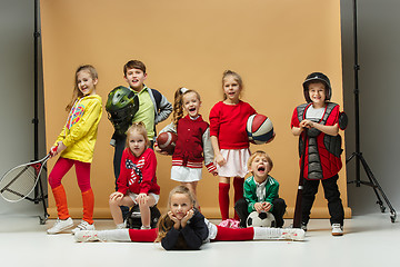 Image showing Group of happy children show different sport. Studio fashion concept. Emotions concept.