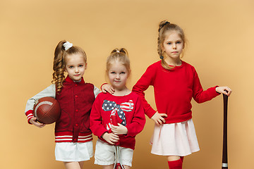 Image showing Happy and beautyful children show different sport. Studio fashion concept. Emotions concept.