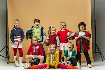 Image showing Group of happy children show different sport. Studio fashion concept. Emotions concept.